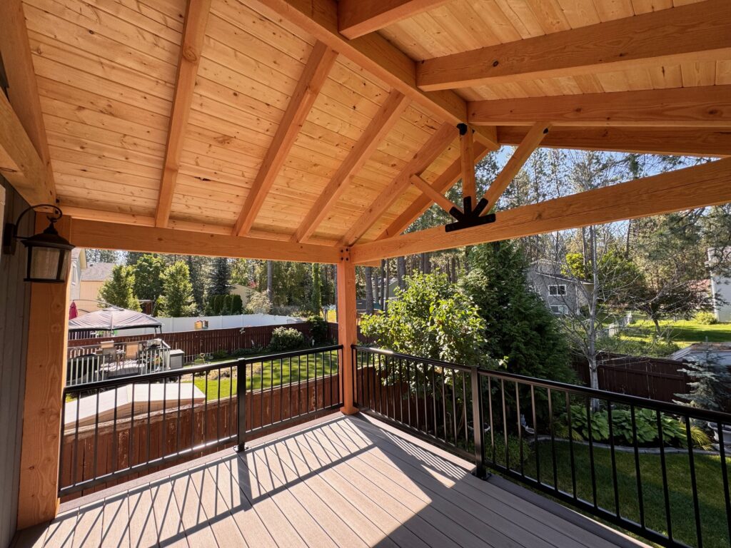Custom-built deck with a modern pergola providing shade and style in a Spokane backyard